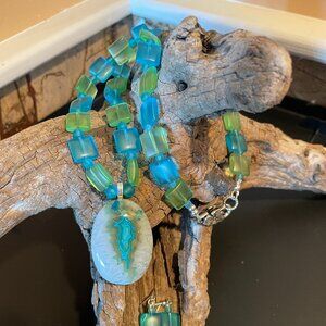 A stunning blue Onyx Agate Druzy pendant strung with square sea glass beads